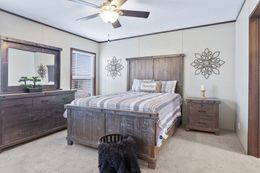 The BREEZE FARMHOUSE Primary Bedroom. This Manufactured Mobile Home features 3 bedrooms and 2 baths.