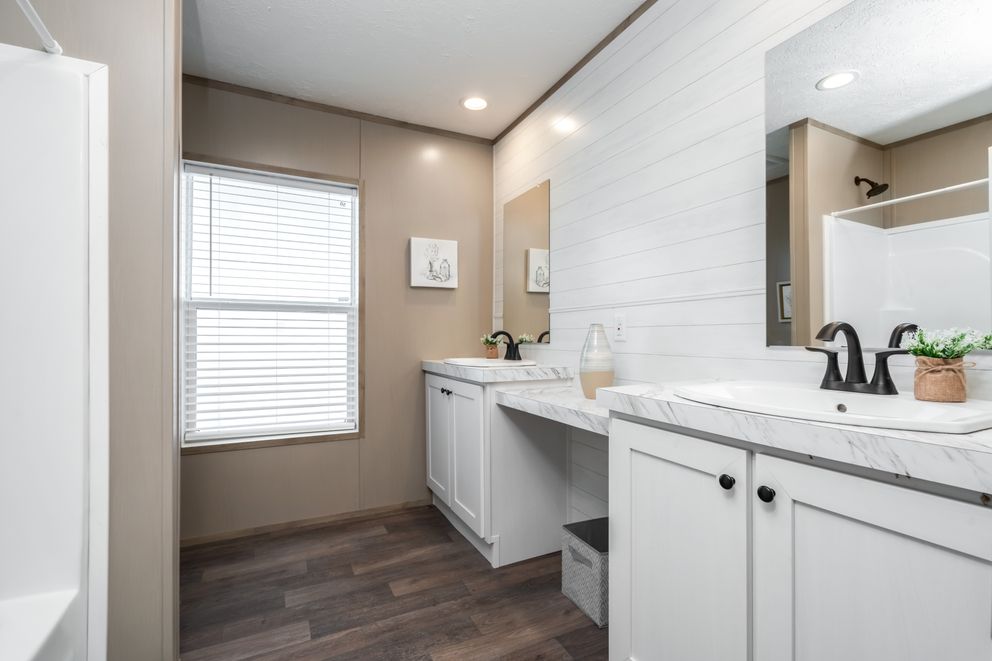The FARMHOUSE BREEZE 72 Guest Bathroom. This Manufactured Mobile Home features 4 bedrooms and 2 baths.