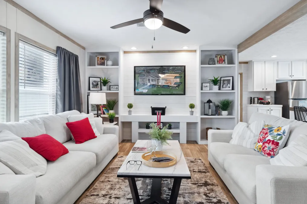 The THE REAL DEAL Living Room. This Manufactured Mobile Home features 3 bedrooms and 2 baths.