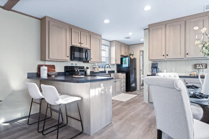 The ANNIVERSARY 16763A Kitchen. This Manufactured Mobile Home features 3 bedrooms and 2 baths.