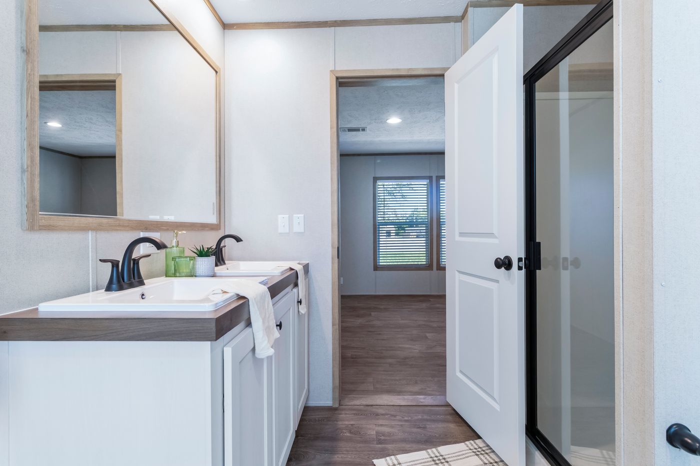 The THE BIG DEAL 52 Primary Bathroom. This Manufactured Mobile Home features 3 bedrooms and 2 baths.