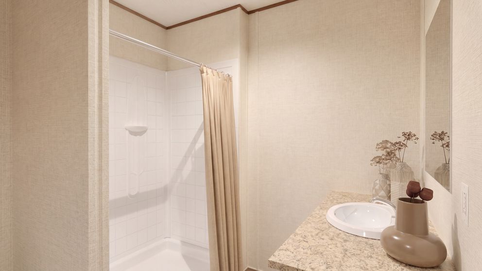 The REDWOOD Primary Bathroom. This Manufactured Mobile Home features 5 bedrooms and 3 baths.