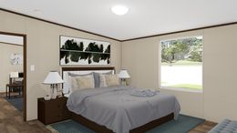 The EXCITEMENT Primary Bedroom. This Manufactured Mobile Home features 3 bedrooms and 2 baths.