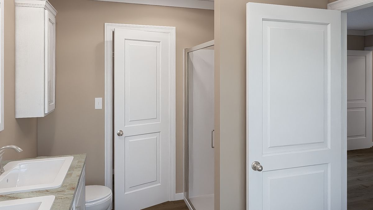 The THE DREAM Primary Bathroom. This Manufactured Mobile Home features 3 bedrooms and 2 baths.