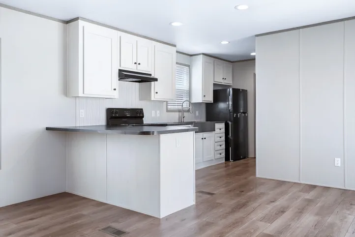 The ANNIVERSARY 16602A Kitchen. This Manufactured Mobile Home features 2 bedrooms and 2 baths.