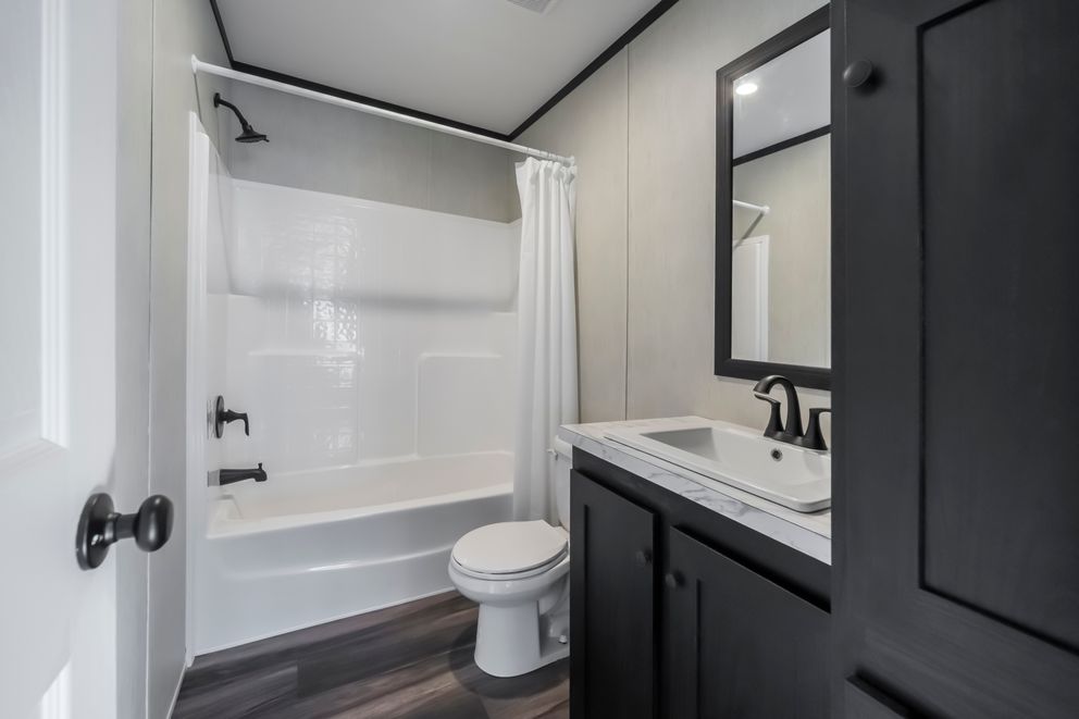The LIL SOUTHERN CHARM Guest Bathroom. This Manufactured Mobile Home features 3 bedrooms and 2 baths.