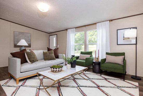 The PRIDE Living Room. This Manufactured Mobile Home features 4 bedrooms and 2 baths.