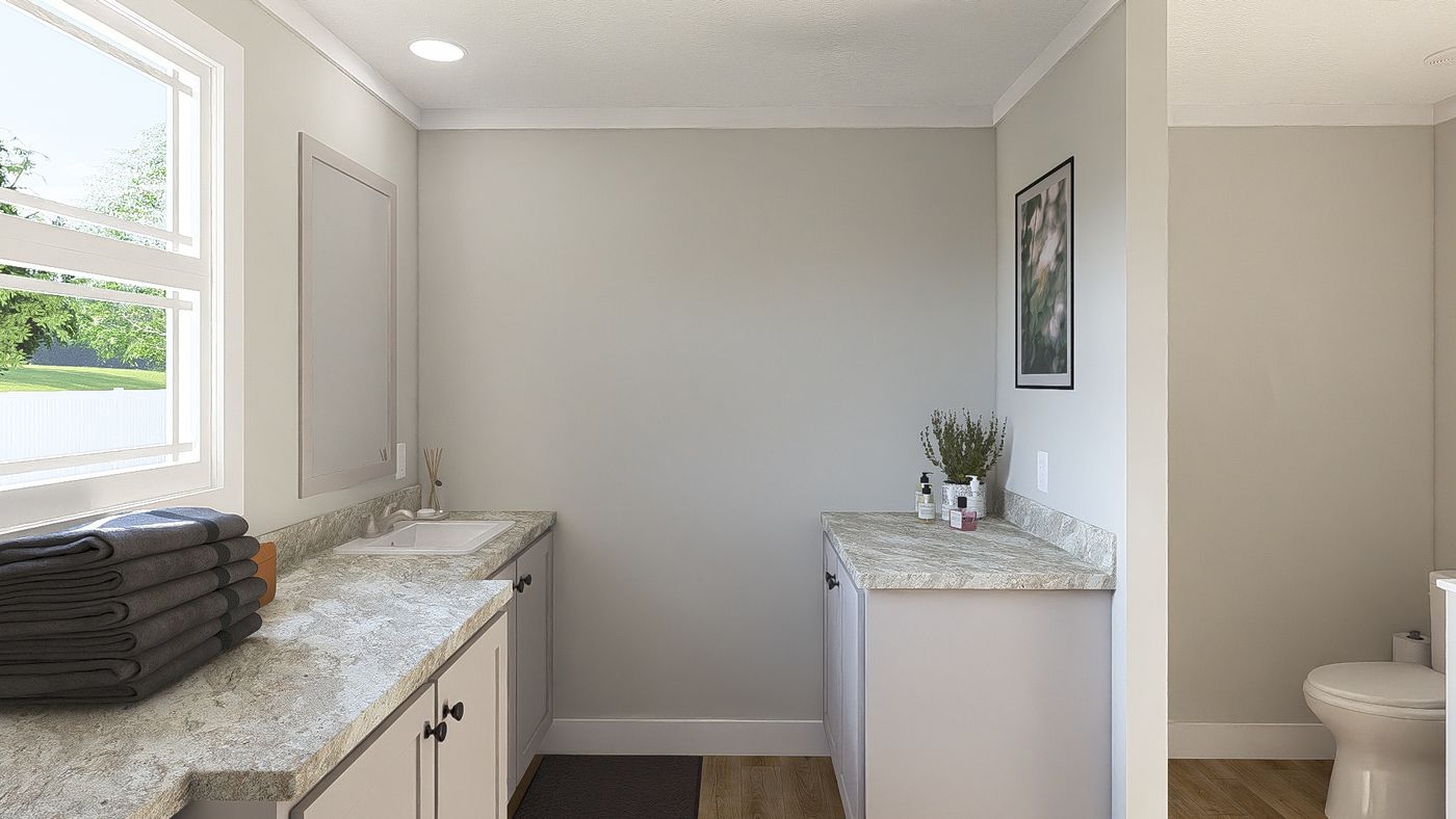 The THE BREEZE 64 Primary Bathroom. This Manufactured Mobile Home features 4 bedrooms and 2 baths.