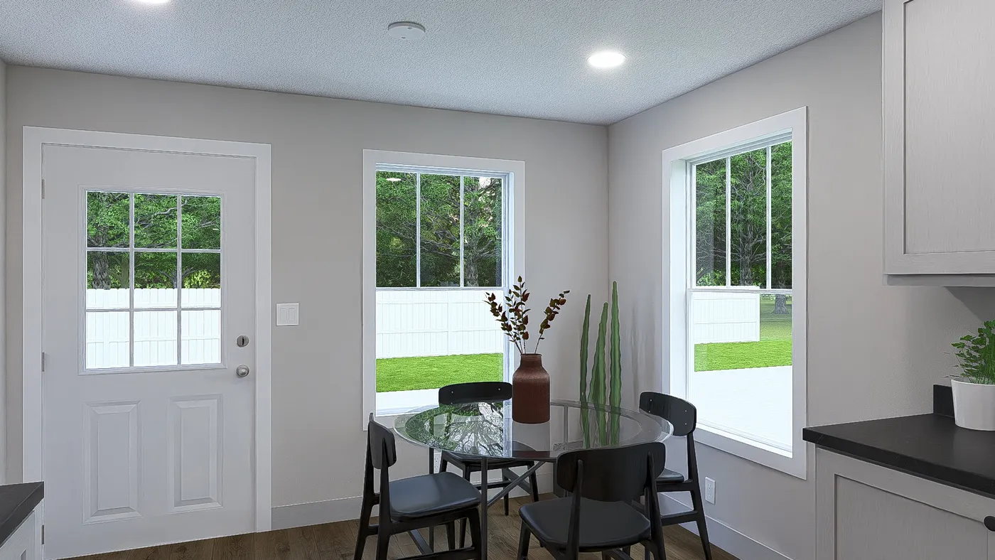 The HERE COMES THE SUN Dining Room. This Manufactured Mobile Home features 3 bedrooms and 2 baths.