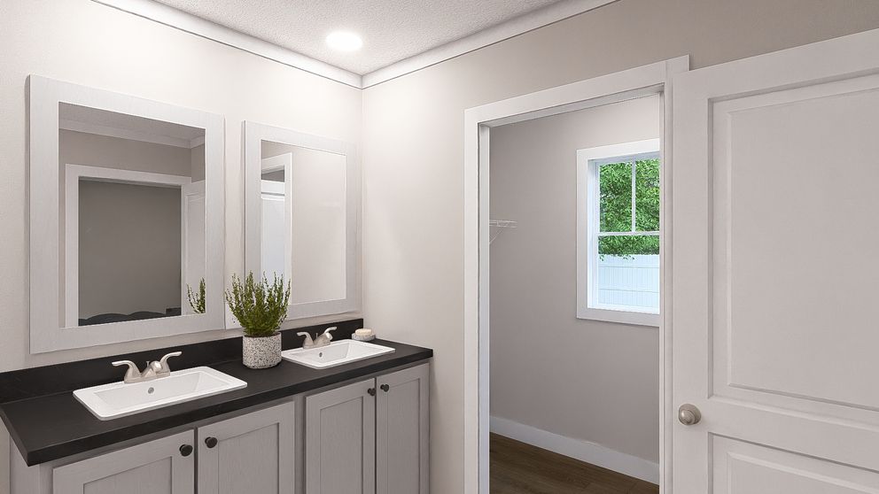 The SWEET CAROLINE Primary Bathroom. This Manufactured Mobile Home features 3 bedrooms and 2 baths.