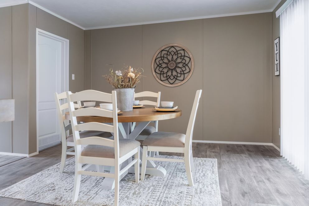 The THE RESERVE 60 Dining Room. This Manufactured Mobile Home features 3 bedrooms and 2 baths.