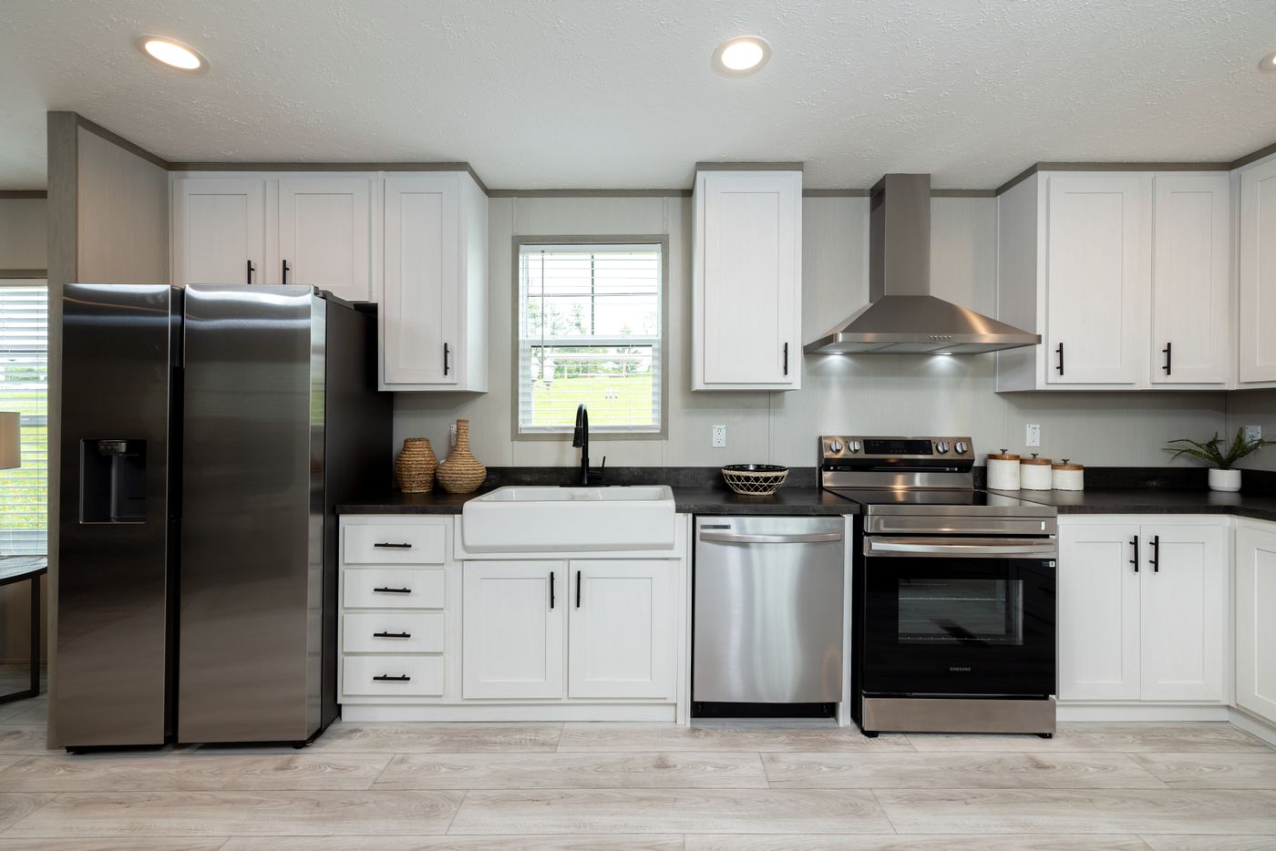 The SHOWER HOUSE Kitchen. This Manufactured Mobile Home features 3 bedrooms and 2 baths.