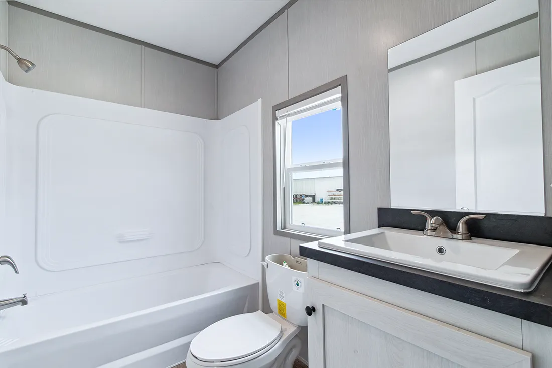 The ANNIVERSARY 16682F Guest Bathroom. This Manufactured Mobile Home features 2 bedrooms and 2 baths.