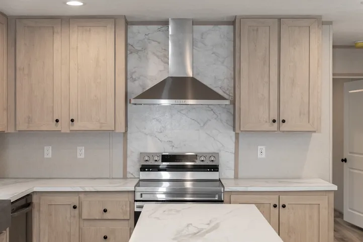 The THE ANNIVERSARY ISLANDER Kitchen. This Manufactured Mobile Home features 3 bedrooms and 2 baths.