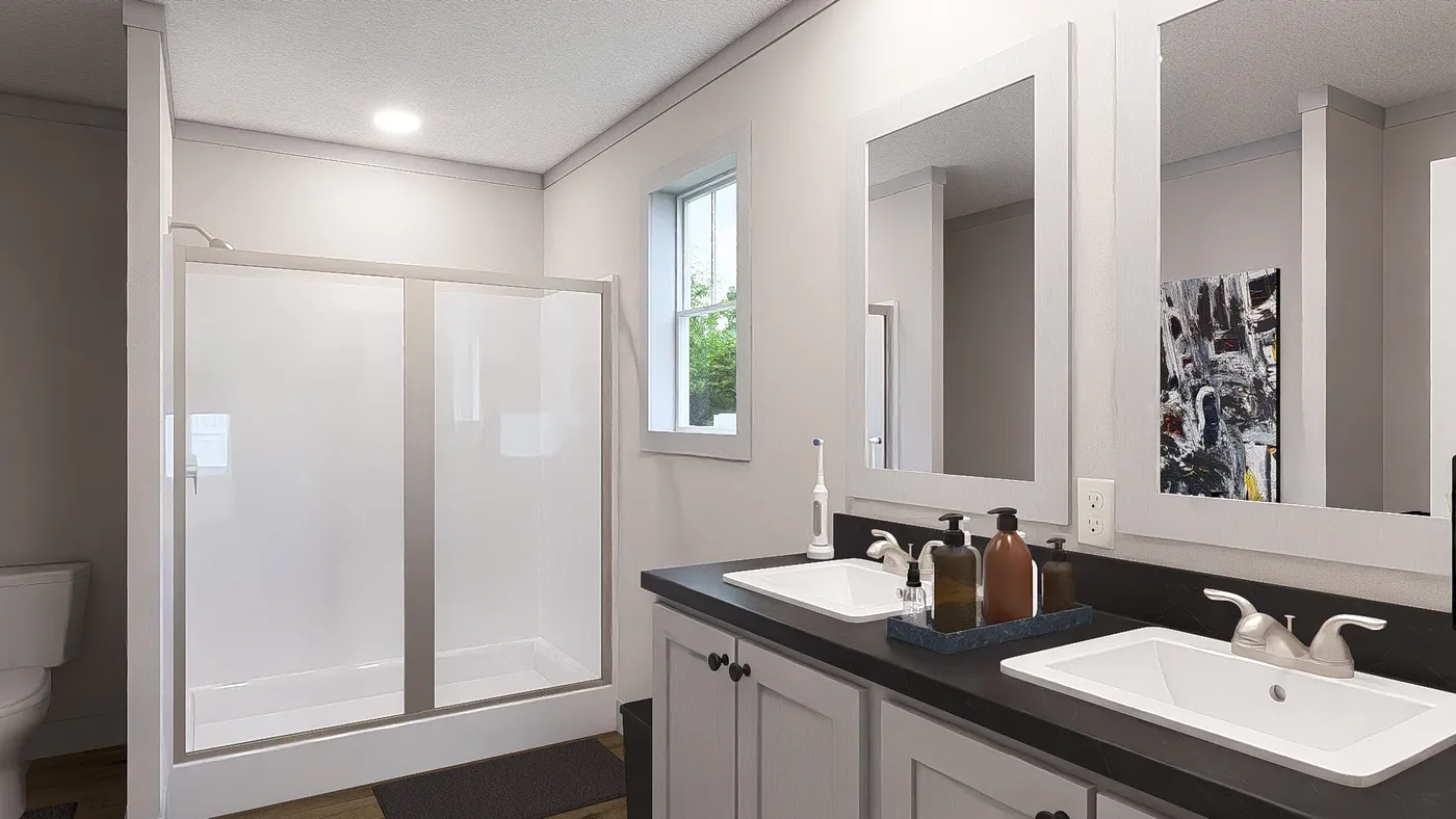 The STAYIN' ALIVE Primary Bathroom. This Manufactured Mobile Home features 3 bedrooms and 2 baths.