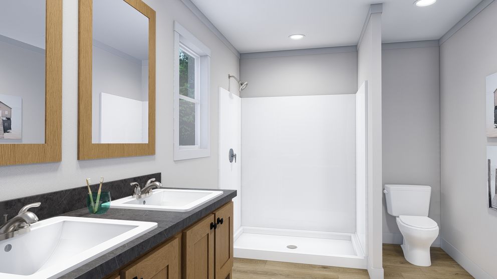 The LOVELY DAY Primary Bathroom. This Manufactured Mobile Home features 4 bedrooms and 2 baths.