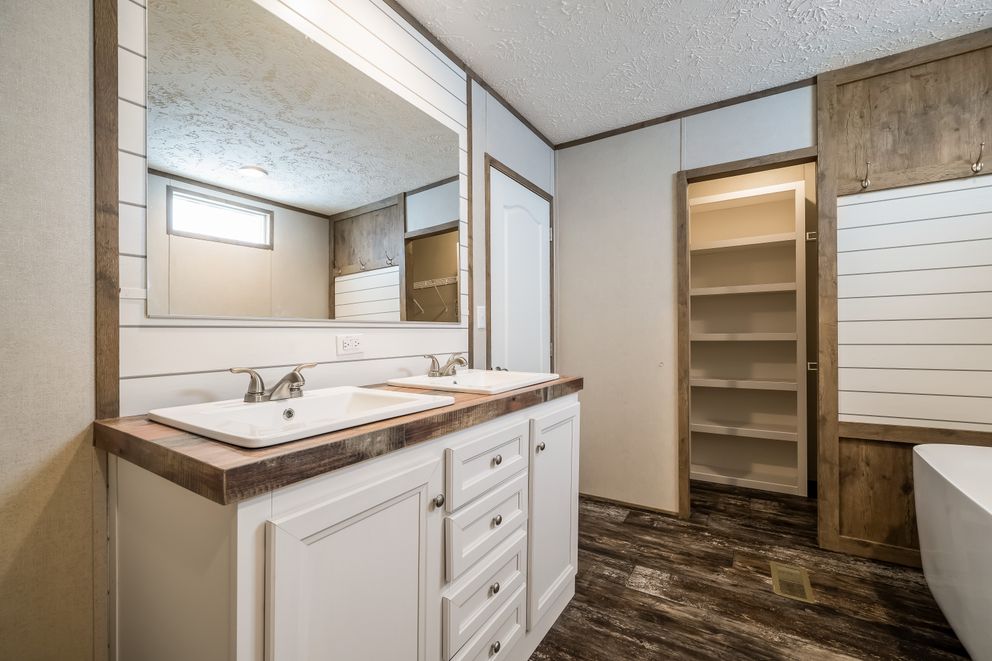 The ANNIVERSARY ENTERTAINER Exterior. This Manufactured Mobile Home features 3 bedrooms and 2 baths.