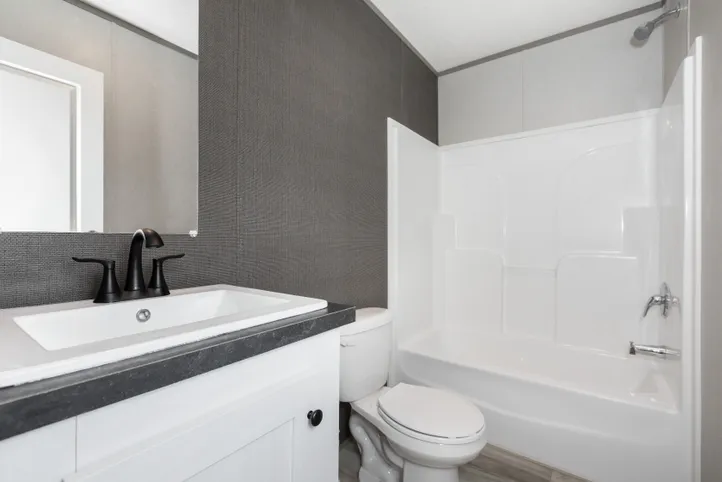 The PLATINUM ANNIVERSARY Guest Bathroom. This Manufactured Mobile Home features 3 bedrooms and 2 baths.