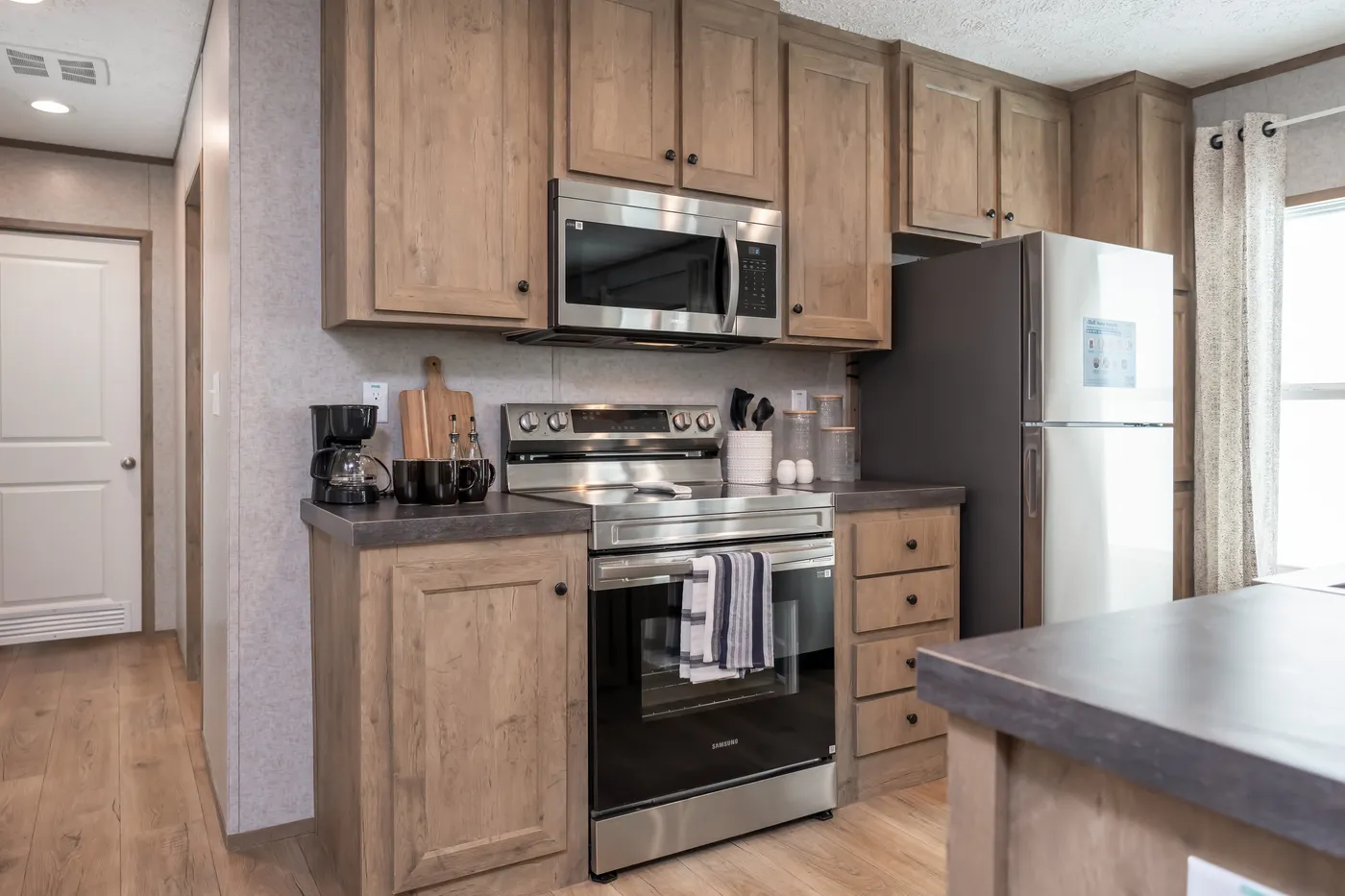 The WARRIOR II Kitchen. This Manufactured Mobile Home features 2 bedrooms and 2 baths.