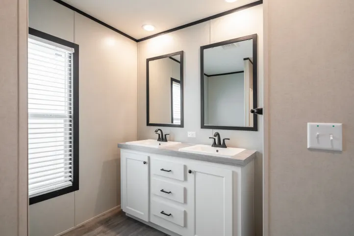 The BREEZE FARMHOUSE Guest Bathroom. This Manufactured Mobile Home features 3 bedrooms and 2 baths.