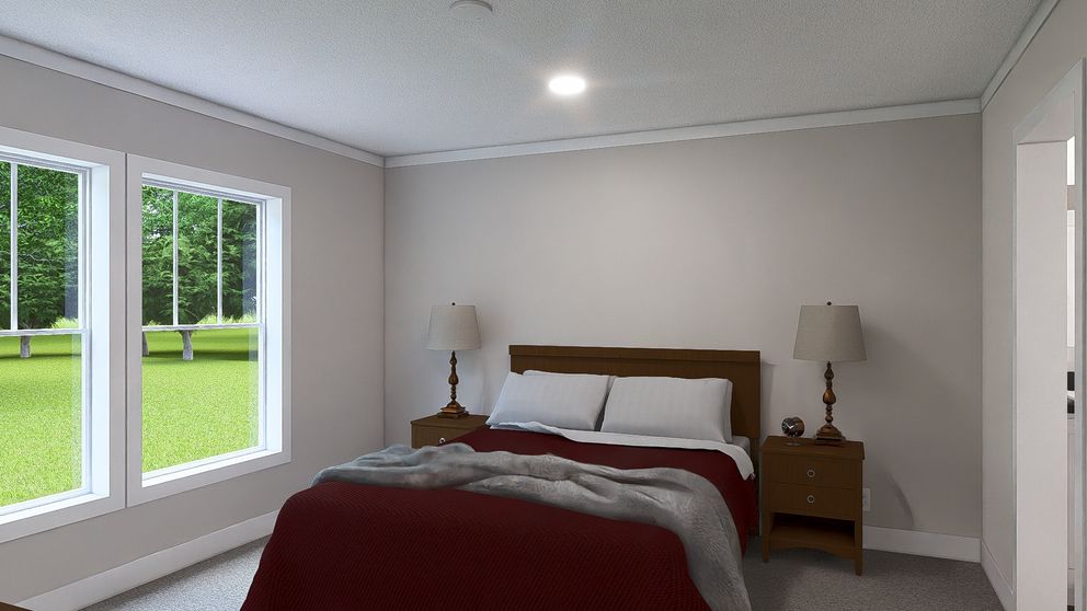 The LET IT BE Primary Bedroom. This Manufactured Mobile Home features 3 bedrooms and 2 baths.
