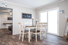 The TRADITION 72 Dining Area. This Manufactured Mobile Home features 4 bedrooms and 2 baths.