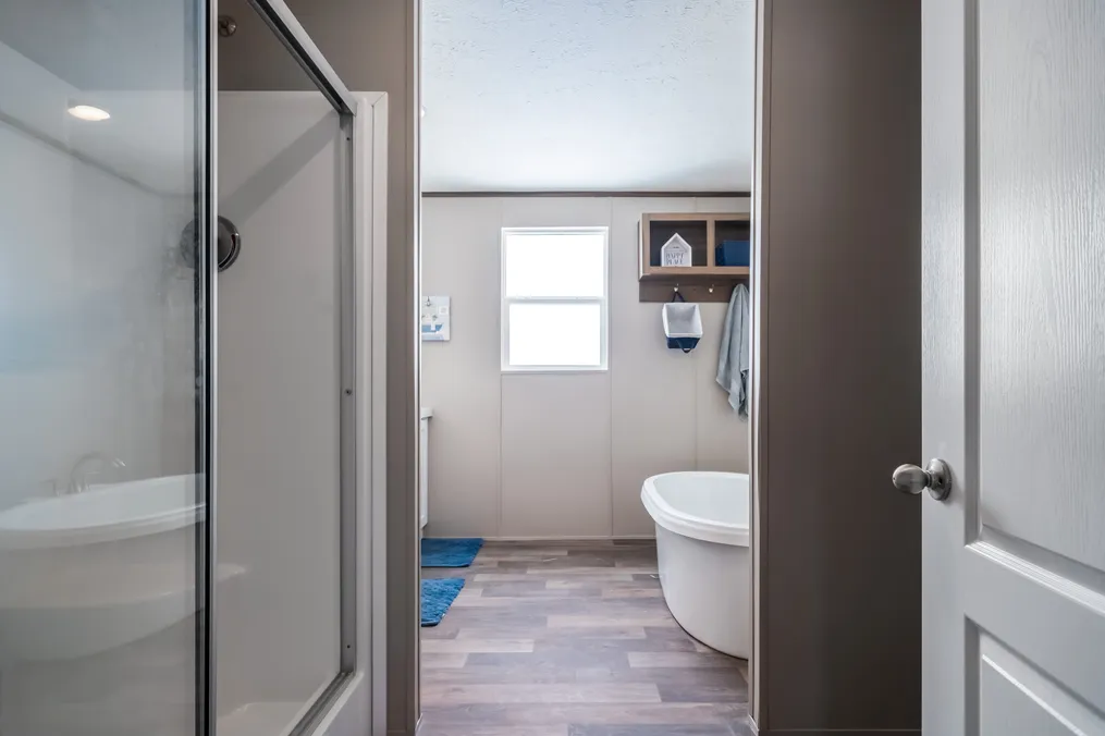 The FARMHOUSE BREEZE 72 Primary Bathroom. This Manufactured Mobile Home features 4 bedrooms and 2 baths.