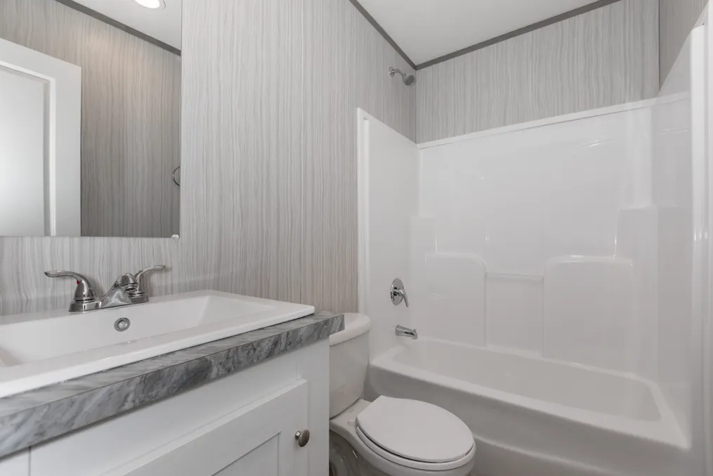 The THE POWERHOUSE Guest Bathroom. This Manufactured Mobile Home features 3 bedrooms and 2 baths.