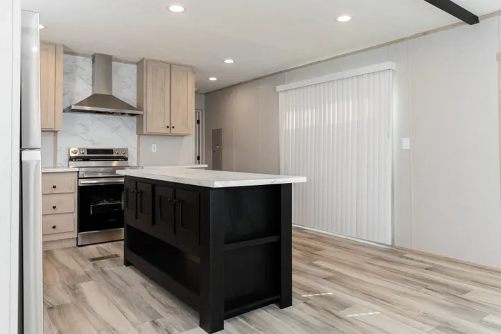 The THE ANNIVERSARY ISLANDER Kitchen. This Manufactured Mobile Home features 3 bedrooms and 2 baths.