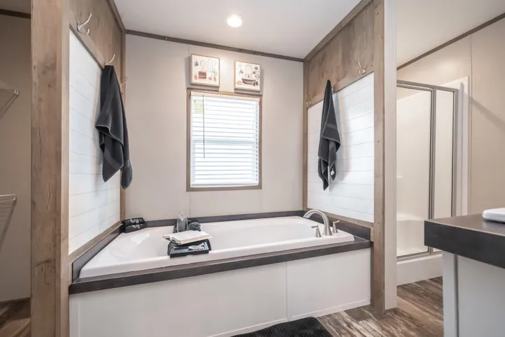 The RIVERHAVEN Primary Bathroom. This Manufactured Mobile Home features 3 bedrooms and 2 baths.