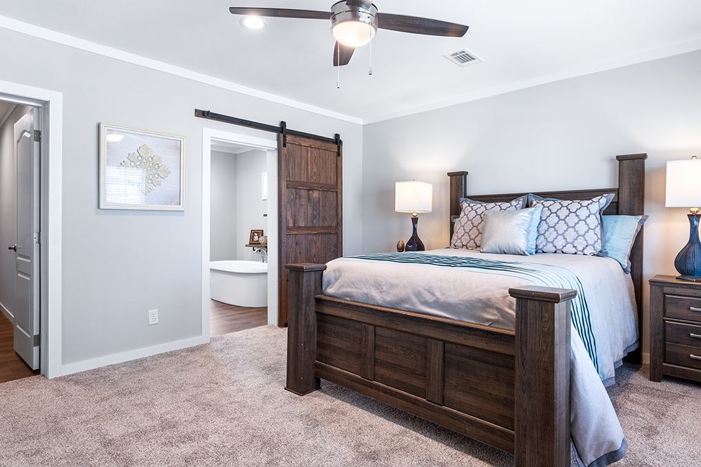 The THE LOUIS Primary Bedroom. This Manufactured Mobile Home features 4 bedrooms and 3 baths.