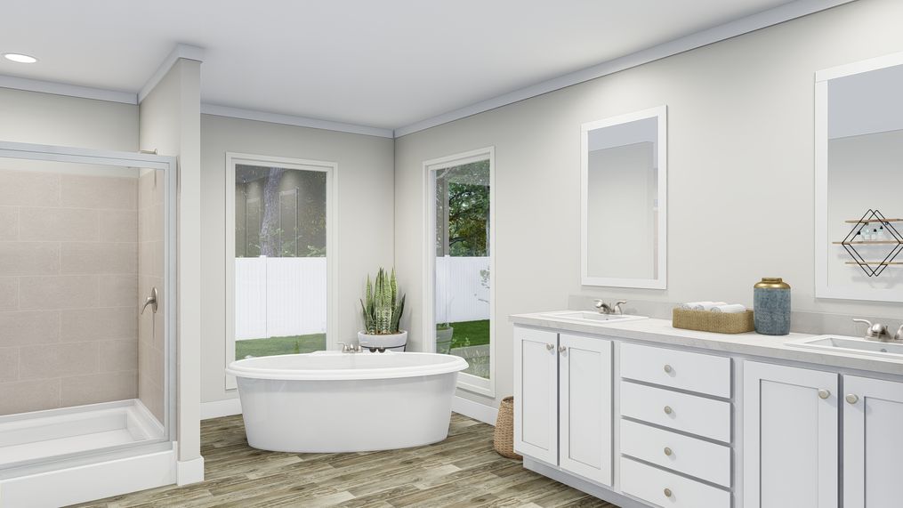The COUNTRY AIRE Primary Bathroom. This Manufactured Mobile Home features 3 bedrooms and 3 baths.