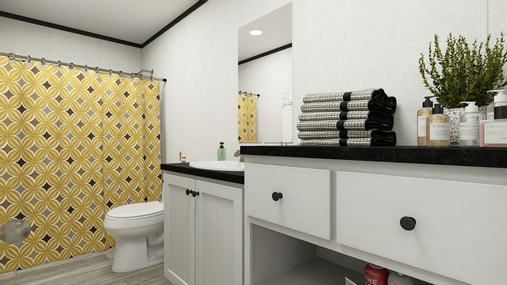 The THE MOUNTAINEER 56 Guest Bathroom. This Manufactured Mobile Home features 3 bedrooms and 2 baths.