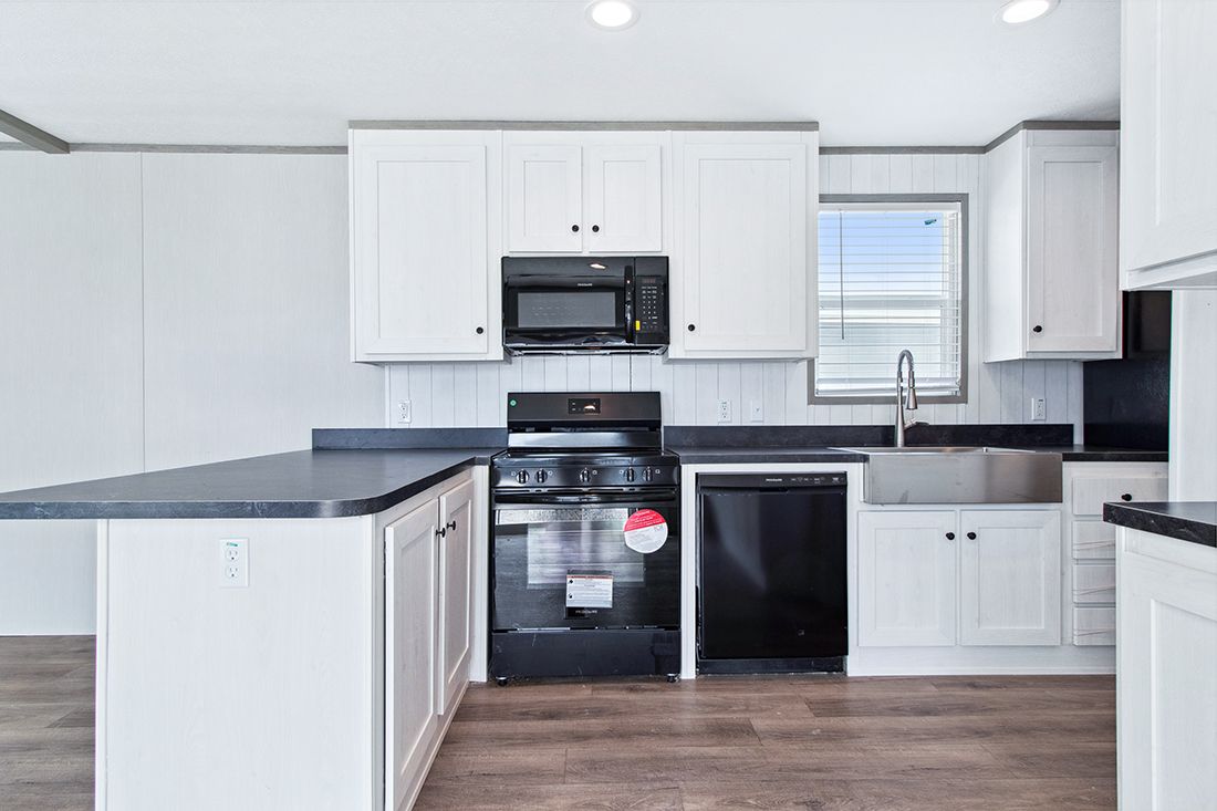 The ANNIVERSARY 16682A Kitchen. This Manufactured Mobile Home features 2 bedrooms and 2 baths.