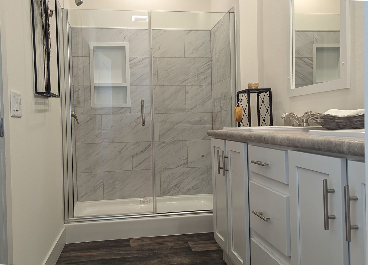 The 50TH ANNIVERSARY Primary Bathroom. This Manufactured Mobile Home features 3 bedrooms and 2 baths.