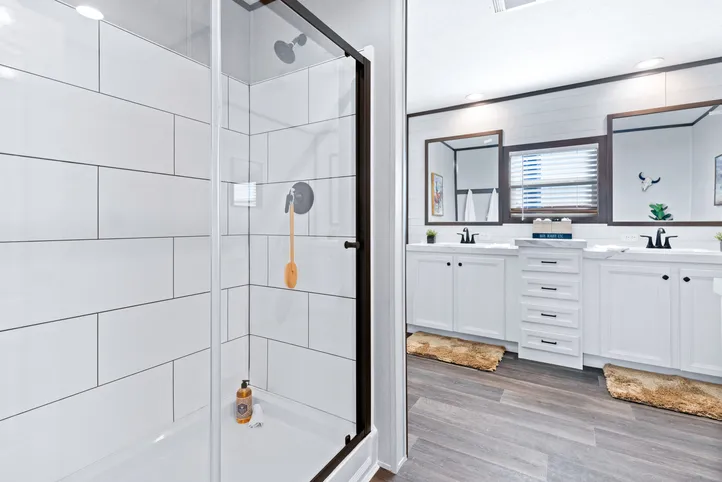 The BREEZE FARMHOUSE Primary Bathroom. This Manufactured Mobile Home features 3 bedrooms and 2 baths.