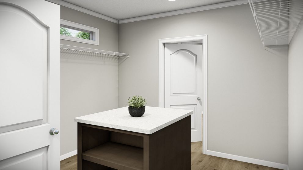 The HUXTON II Primary Bedroom. This Manufactured Mobile Home features 4 bedrooms and 2 baths.