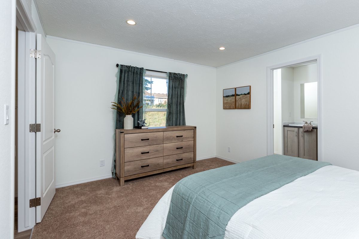The LIFESTYLE 208 Primary Bedroom. This Manufactured Mobile Home features 3 bedrooms and 2 baths.