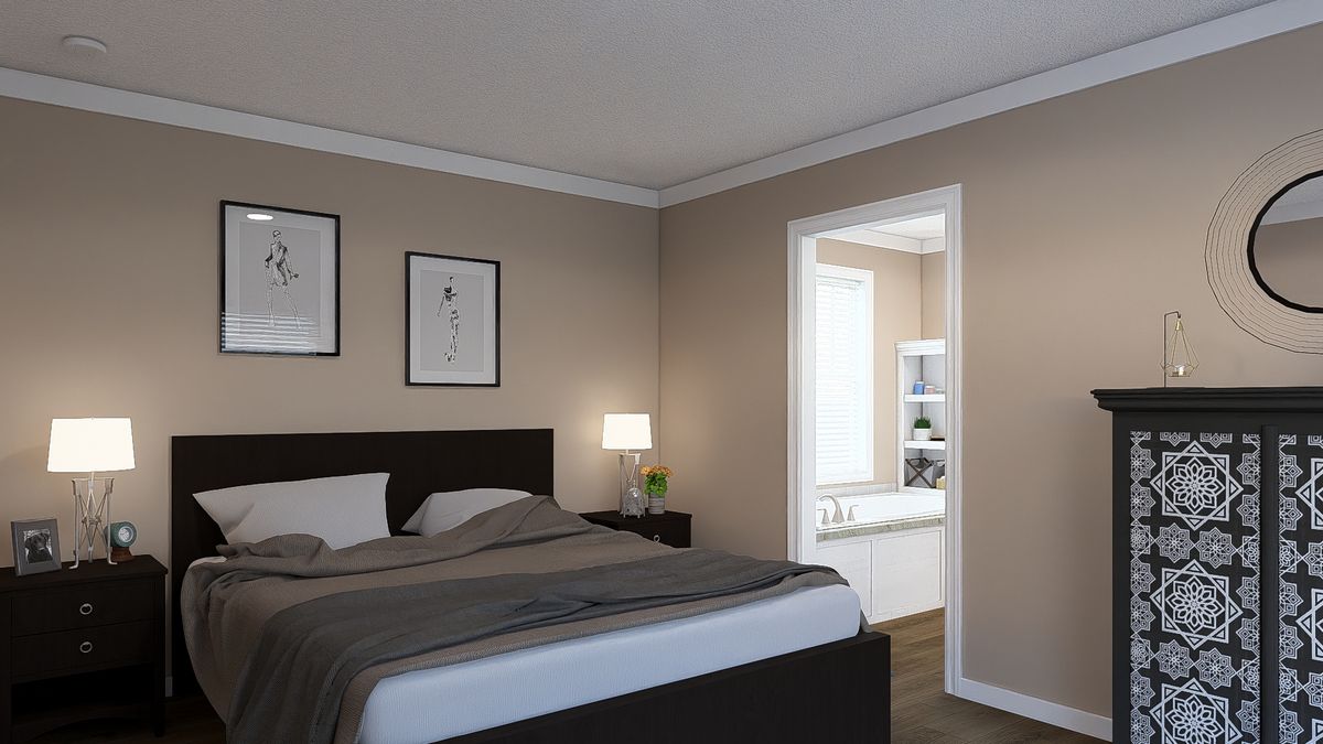 The THE DREAM Primary Bedroom. This Manufactured Mobile Home features 3 bedrooms and 2 baths.