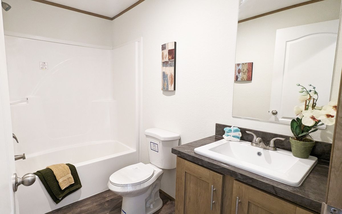 The LIFESTYLE 65-2 Guest Bathroom. This Manufactured Mobile Home features 3 bedrooms and 2 baths.
