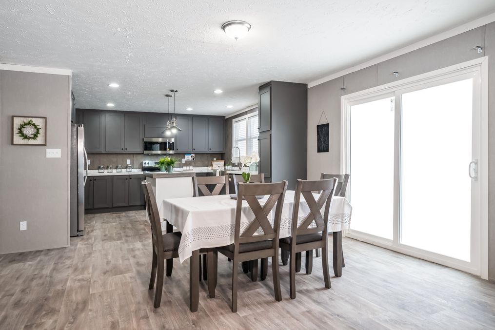 The THE FUSION 32B Dining Area. This Manufactured Mobile Home features 4 bedrooms and 2 baths.