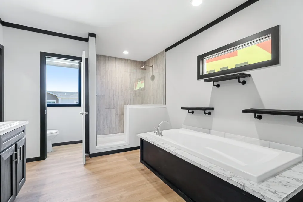 The THE ARMANI Primary Bathroom. This Manufactured Mobile Home features 3 bedrooms and 2 baths.