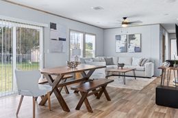 The EL SUENO BREEZE Dining Area. This Manufactured Mobile Home features 4 bedrooms and 2 baths.