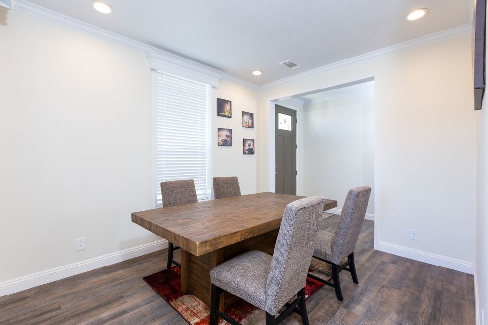 The SUM3076A Dining Room. This Manufactured Mobile Home features 4 bedrooms and 2.5 baths.