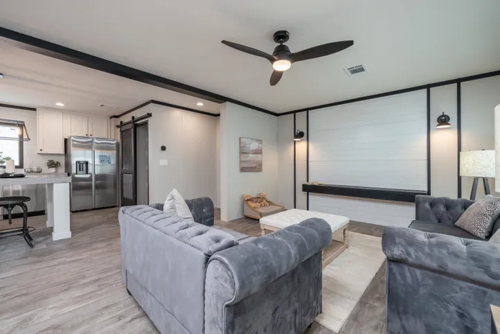The BREEZE FARMHOUSE Living Room. This Manufactured Mobile Home features 3 bedrooms and 2 baths.