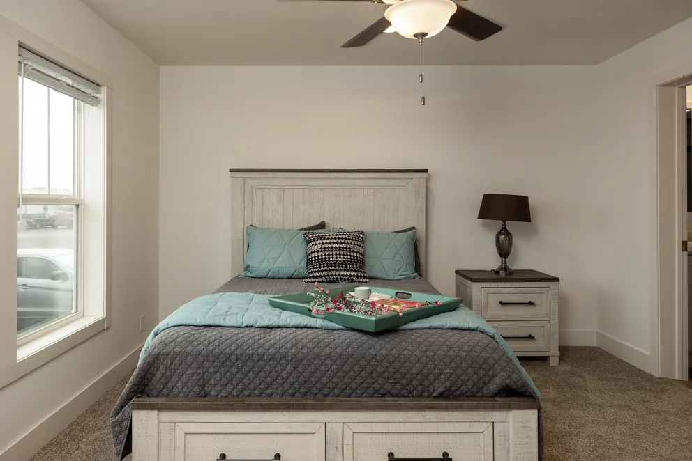 The HEY JUDE Primary Bedroom. This Manufactured Mobile Home features 4 bedrooms and 2 baths.