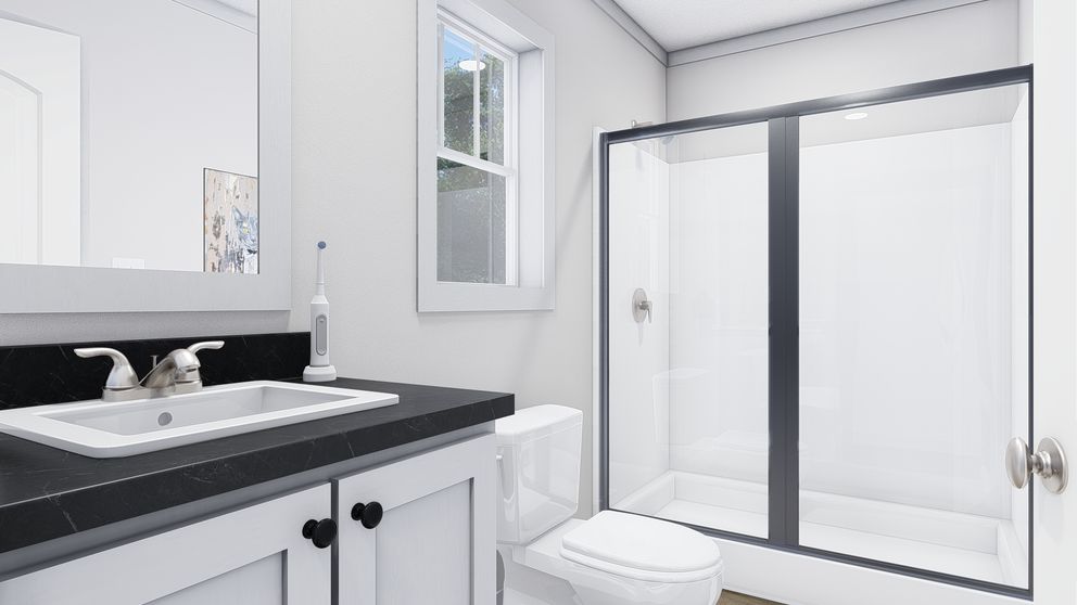 The STILL THE ONE Primary Bathroom. This Manufactured Mobile Home features 2 bedrooms and 2 baths.