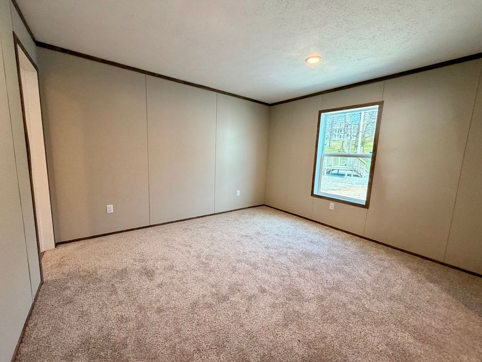 The APATITE Primary Bedroom. This Manufactured Mobile Home features 3 bedrooms and 2 baths.