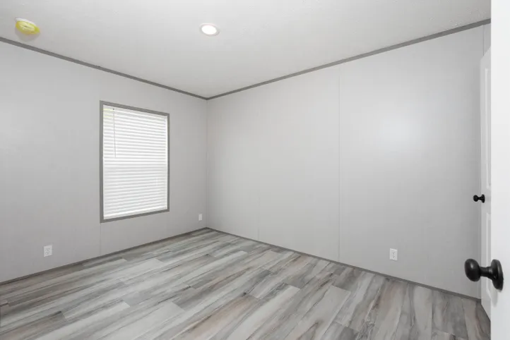 The PLATINUM ANNIVERSARY Guest Bedroom. This Manufactured Mobile Home features 3 bedrooms and 2 baths.