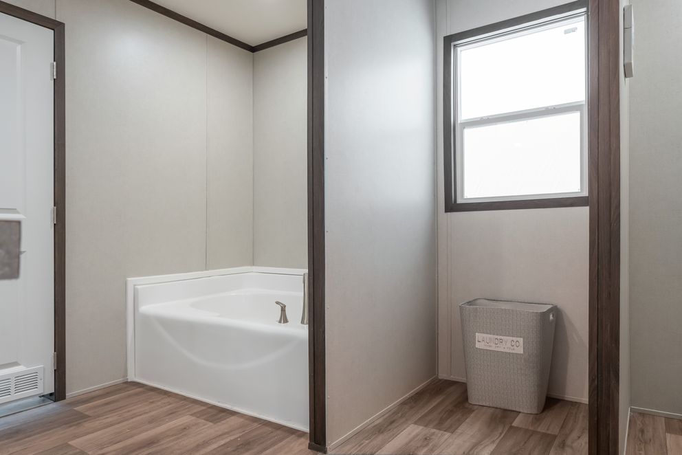 The EMPOWER Primary Bathroom. This Manufactured Mobile Home features 4 bedrooms and 2 baths.